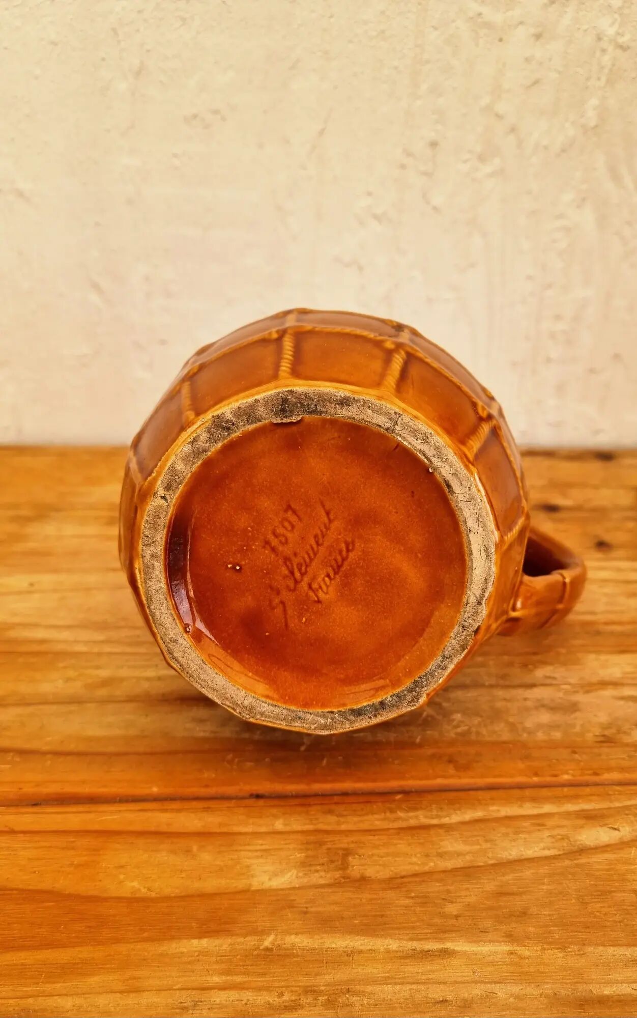 Vintage Saint Clément pitcher with a caramel checkered design.