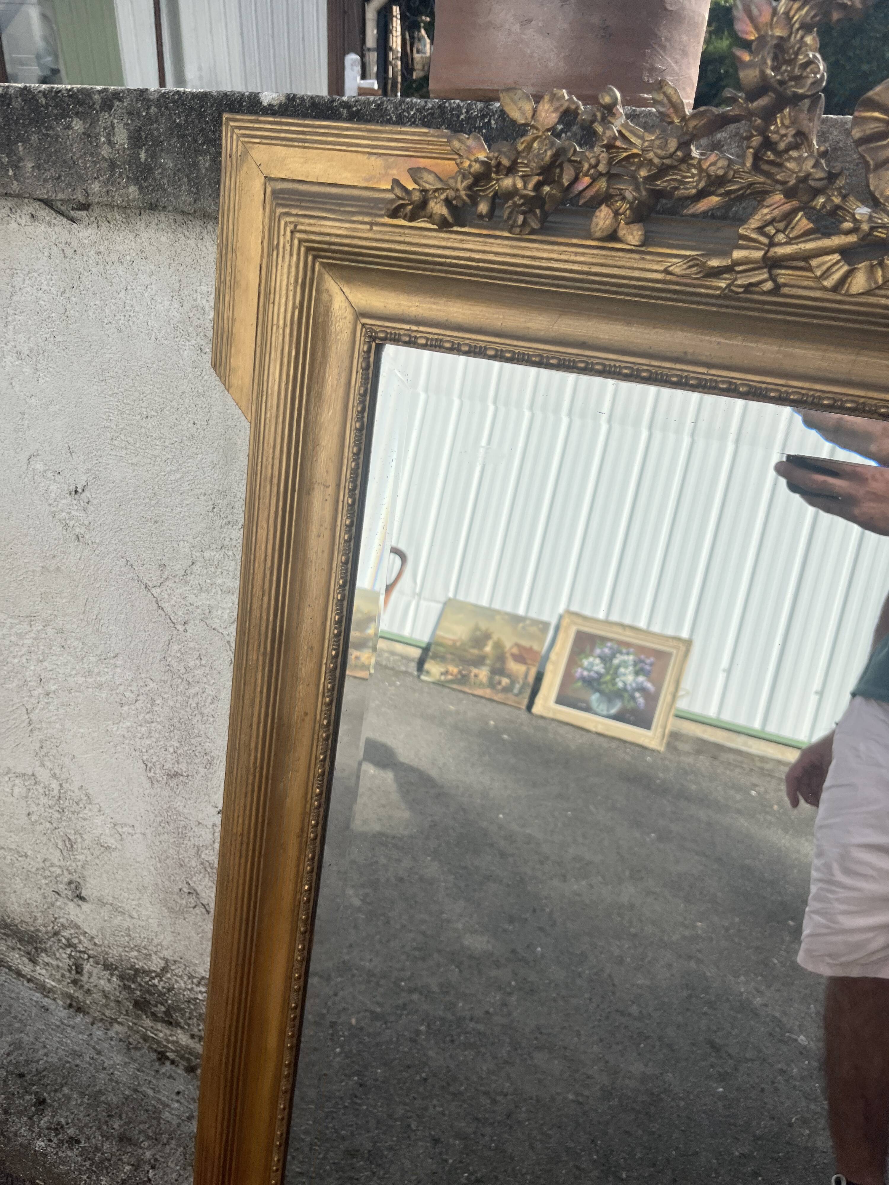 Large antique gilded mirror with carved pediment, 126 cm