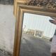 Large antique gilded mirror with carved pediment, 126 cm