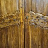 Louis XV period wardrobe façade, solid wood architectural elements, richly carved.
