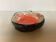 Ceramic tray in orange, white, and black.