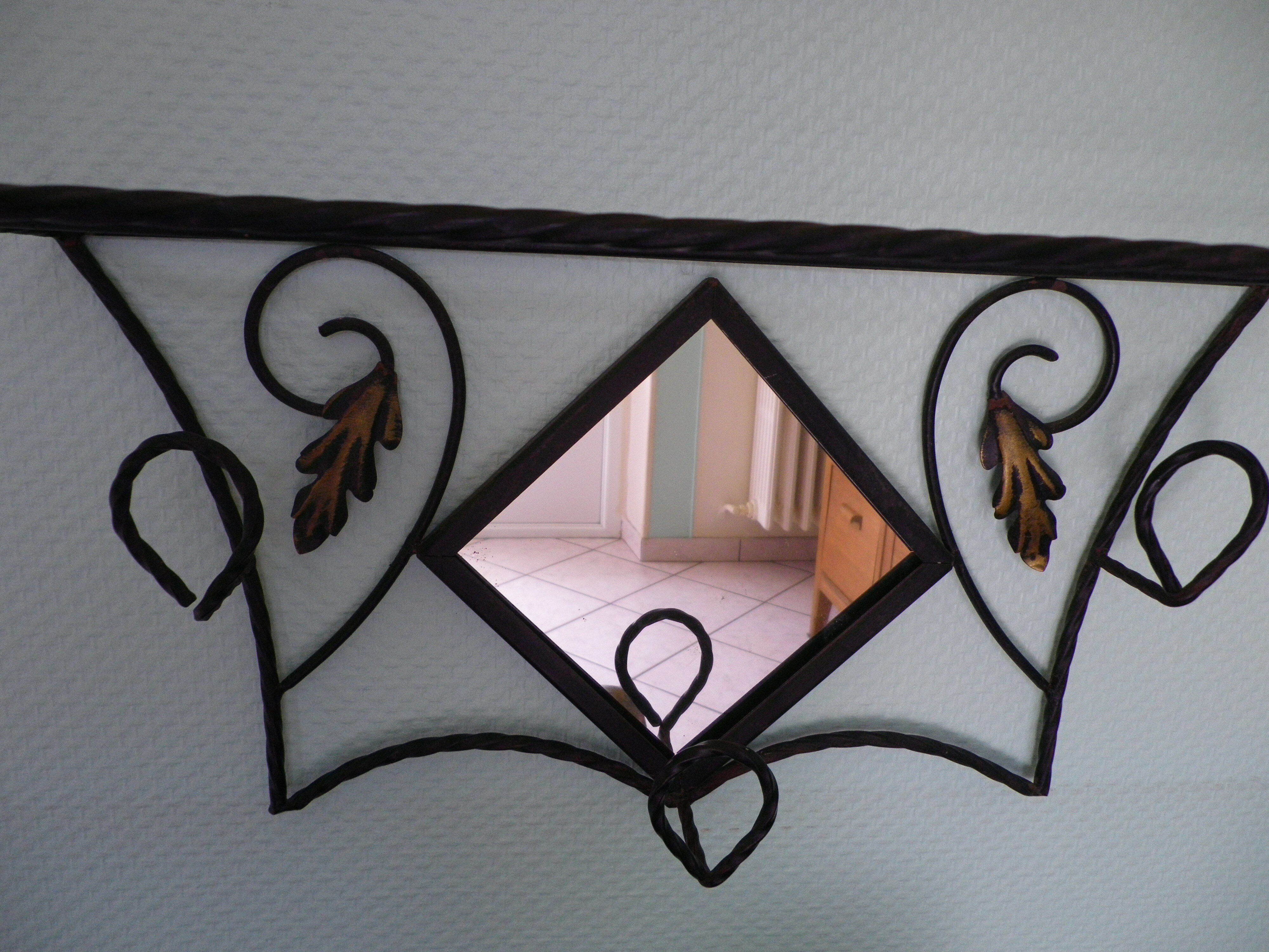 Wrought iron wall holder with top support and built-in mirror