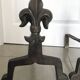 Pair of bronze fireplace firedogs with fleur-de-lys decor, art deco