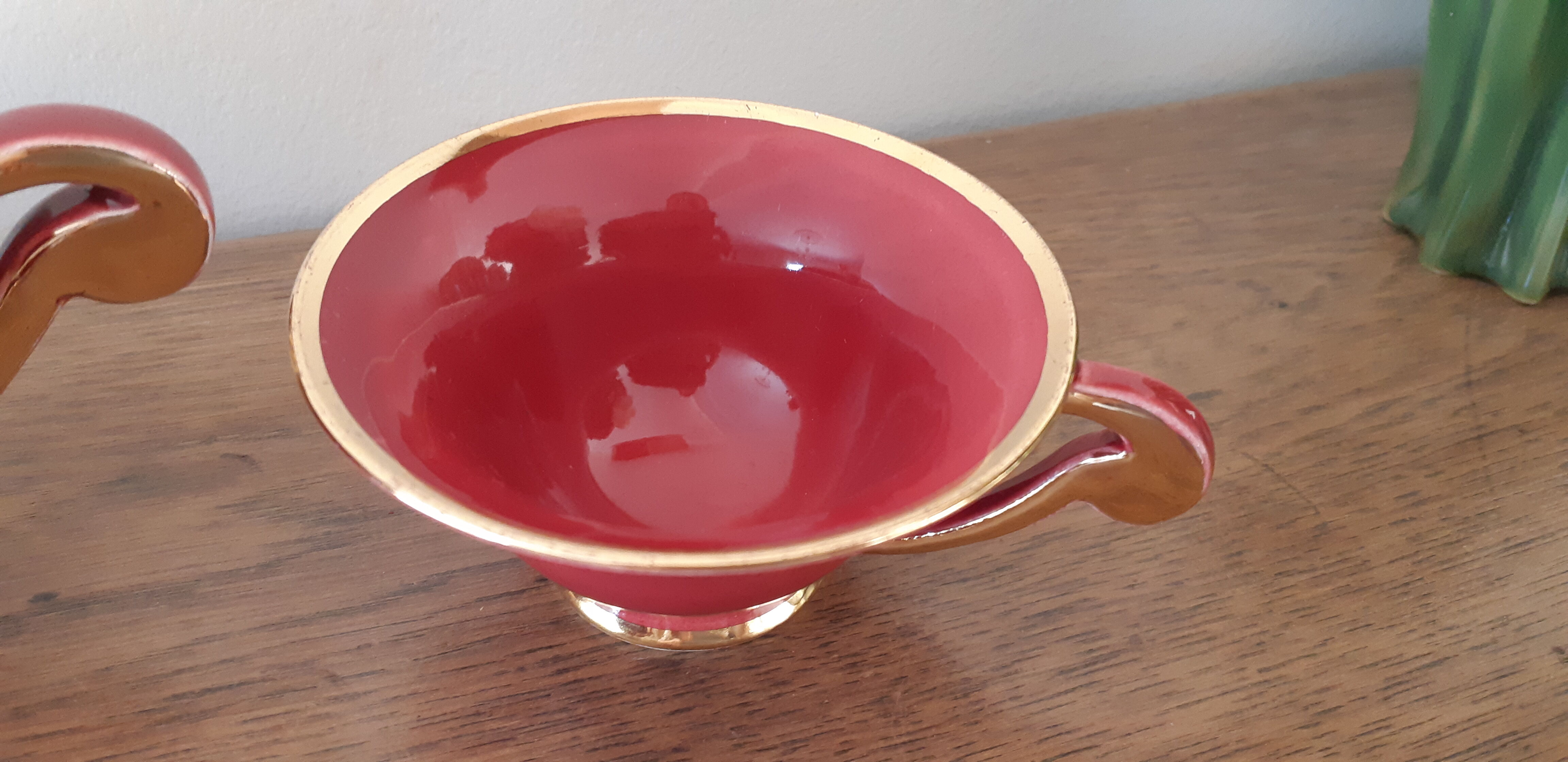 Tea, coffee and sugar cups made of red and gold porcelain