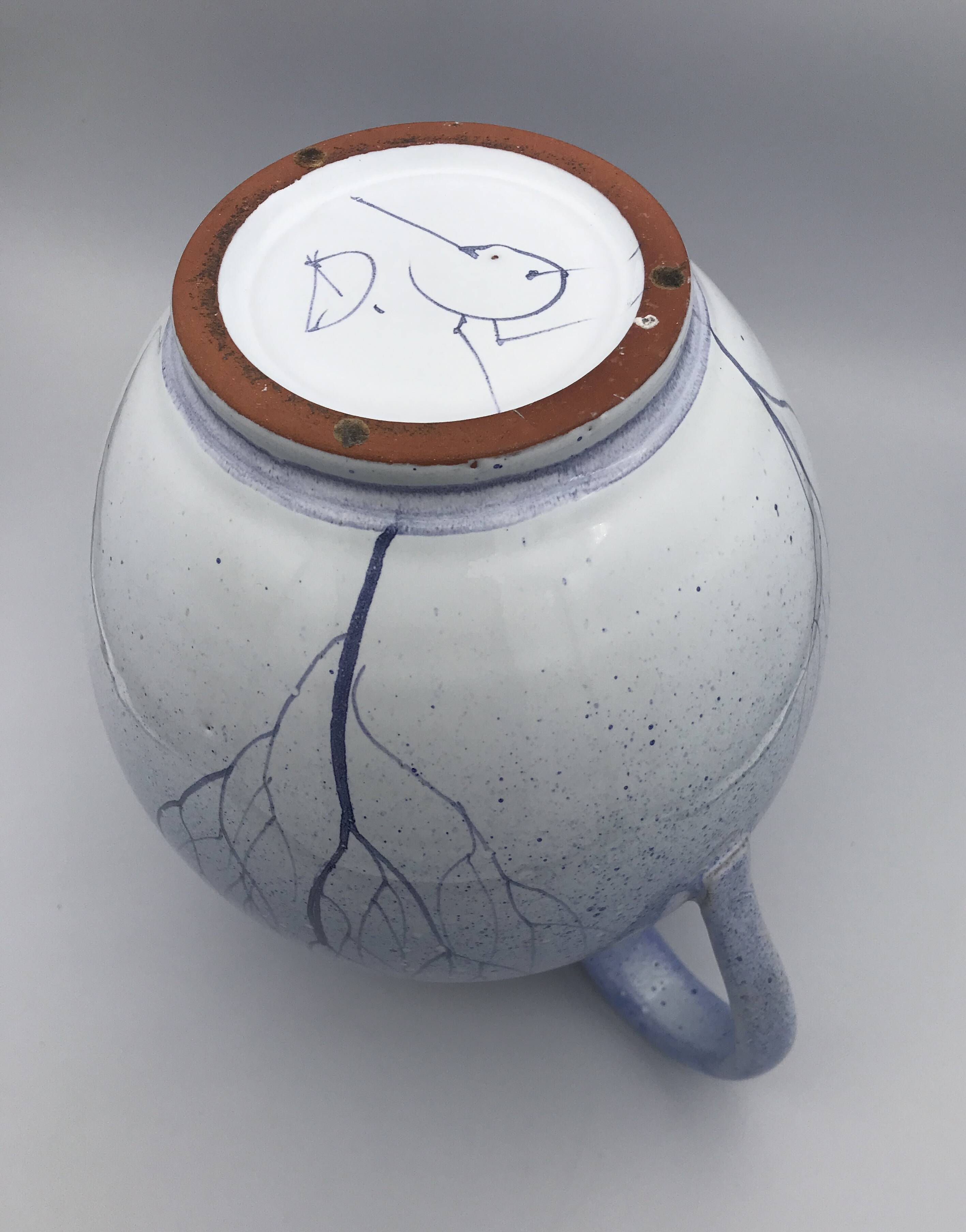 Blue glazed terracotta pitcher with hand-painted decoration, signed