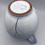 Blue glazed terracotta pitcher with hand-painted decoration, signed