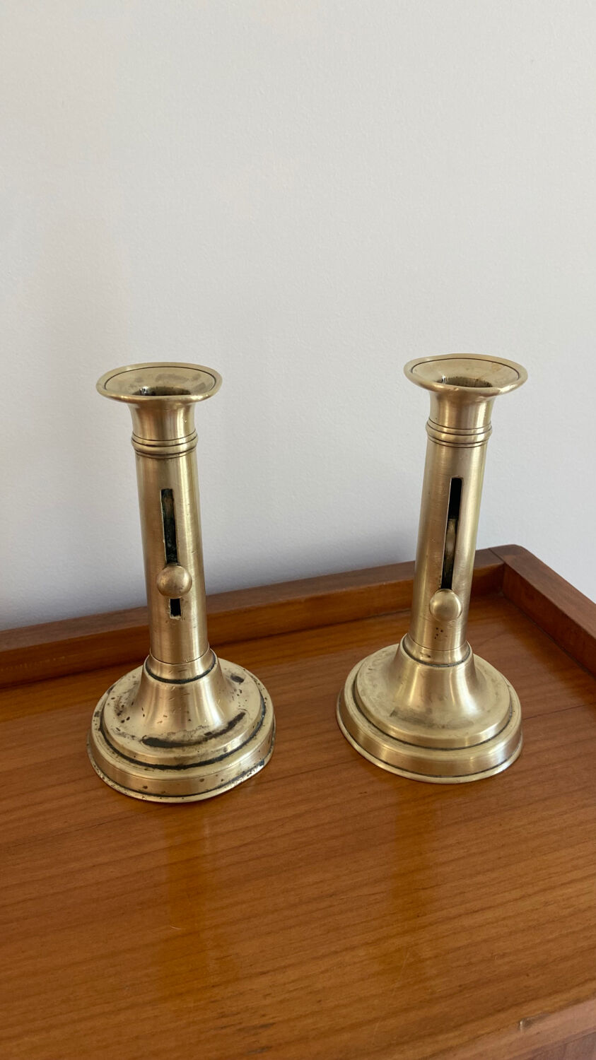 Pair of antique brass push candlesticks