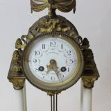 Clock and pair of Louis XVI style candelabras.