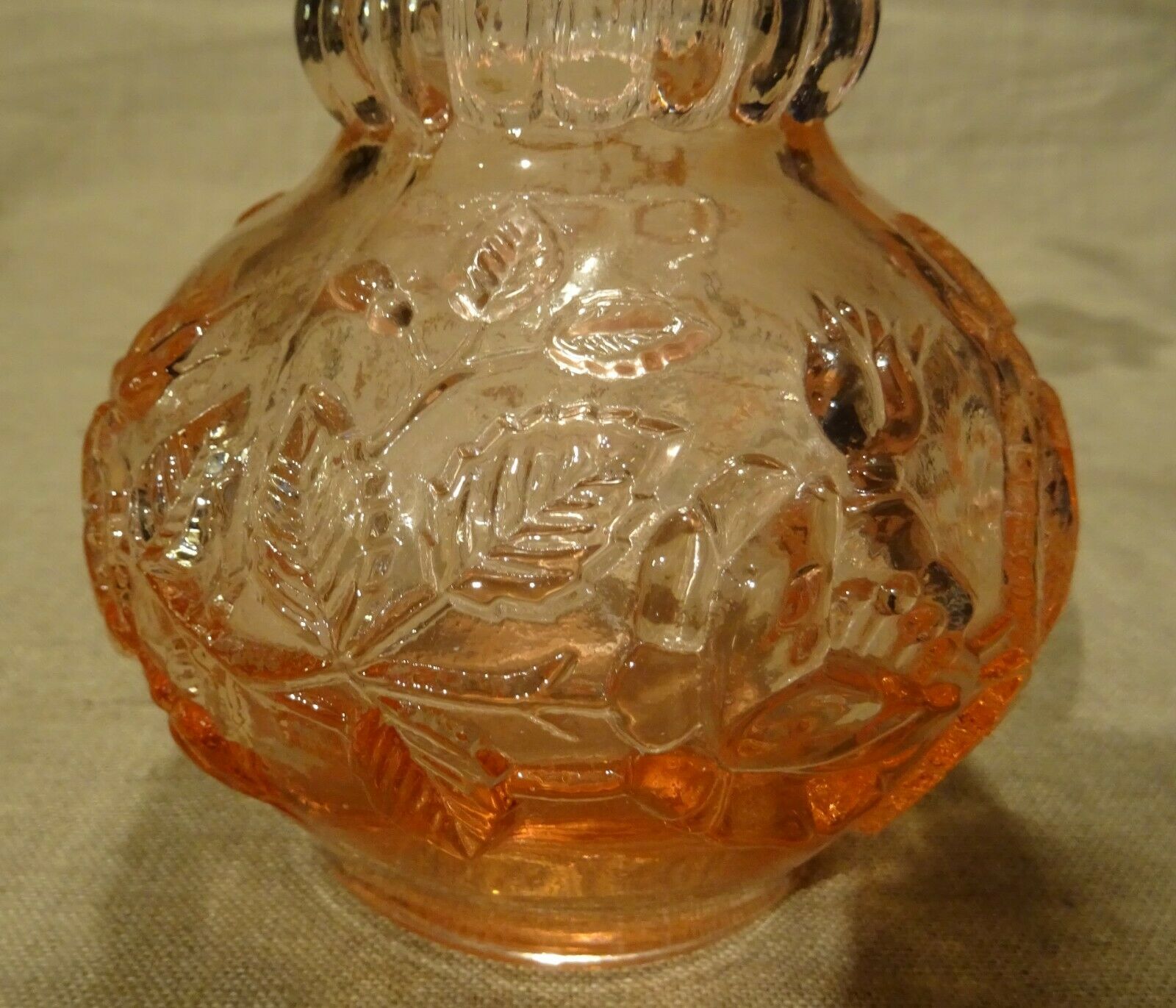 Pink molded pressed glass vase decorated with hazel foliage