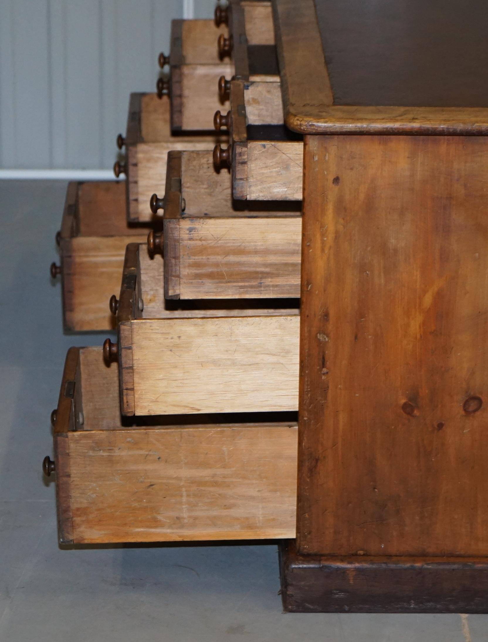 Antique Victorian oak kneehole desk with 18 double-sided drawers.