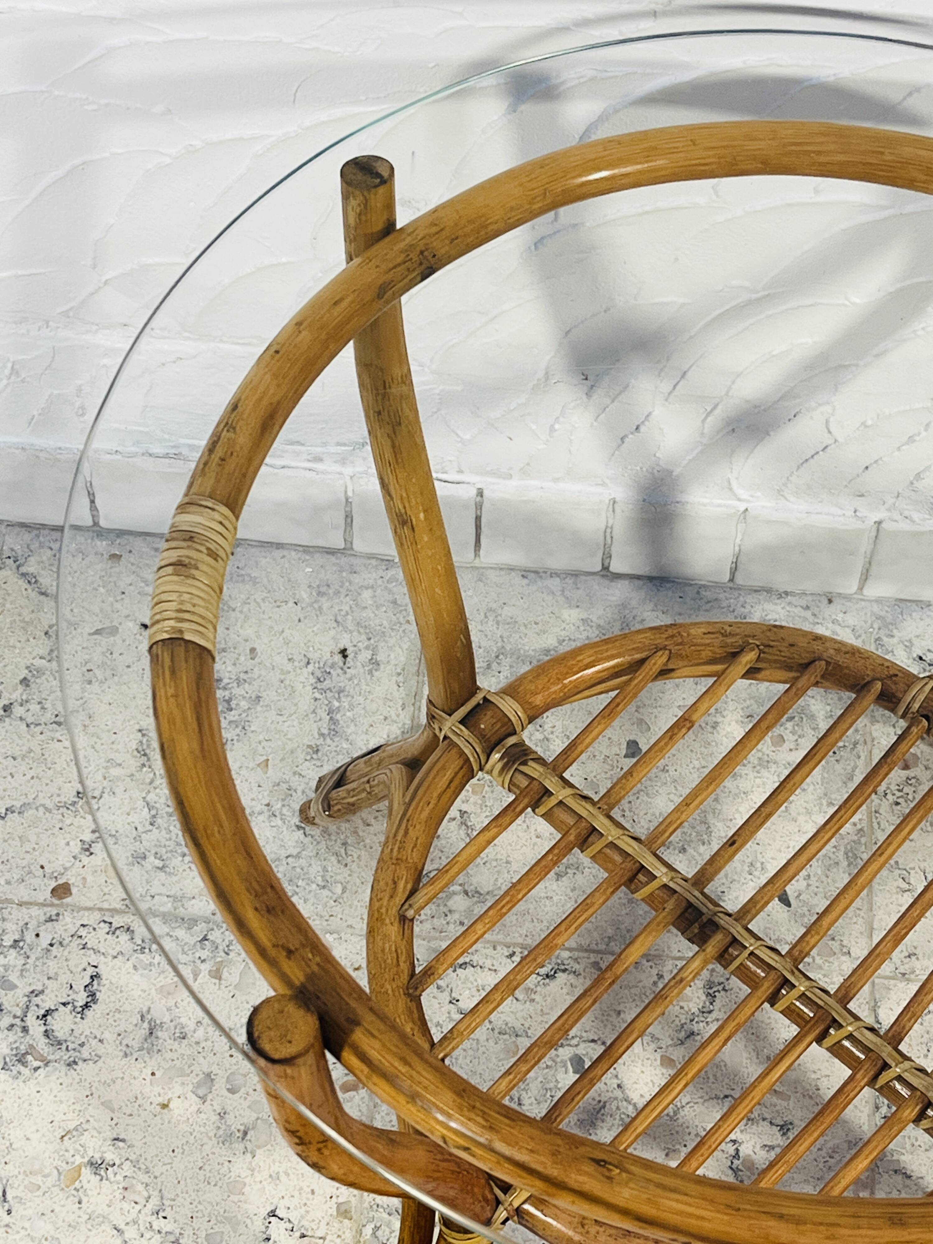 Vintage rattan coffee table with glass top from the 1970s.