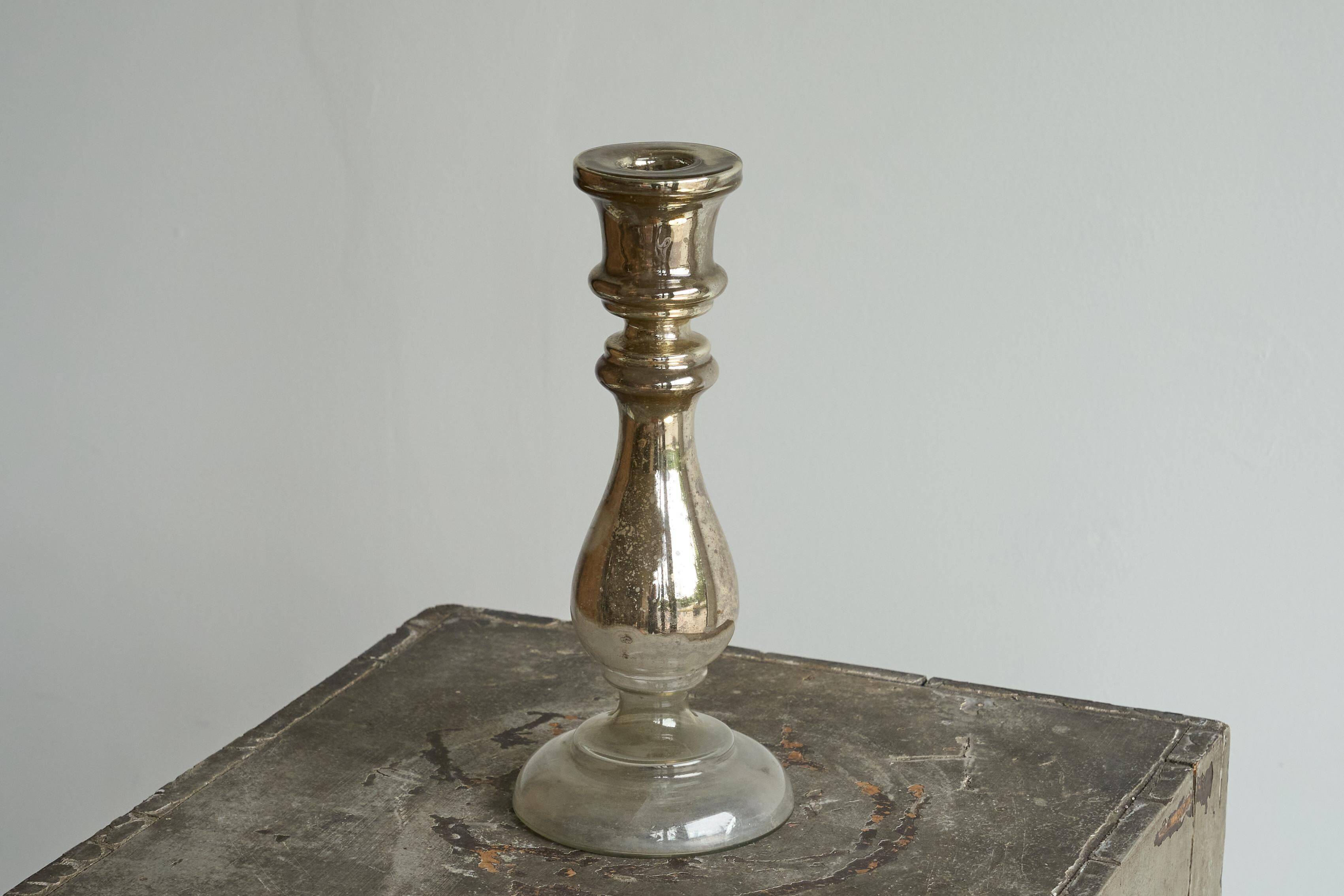 Antique mercury glass candlestick with a patina and silver finish.