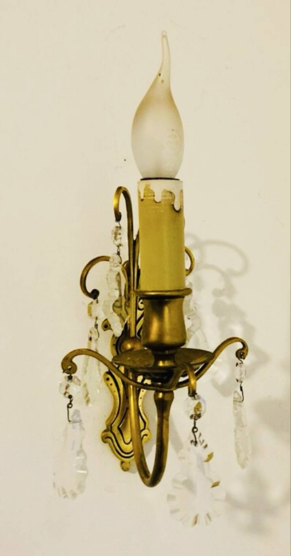 Brass wall light with glass pendants from the mid-20th century.