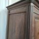 Bonnetière man standing cabinet a door