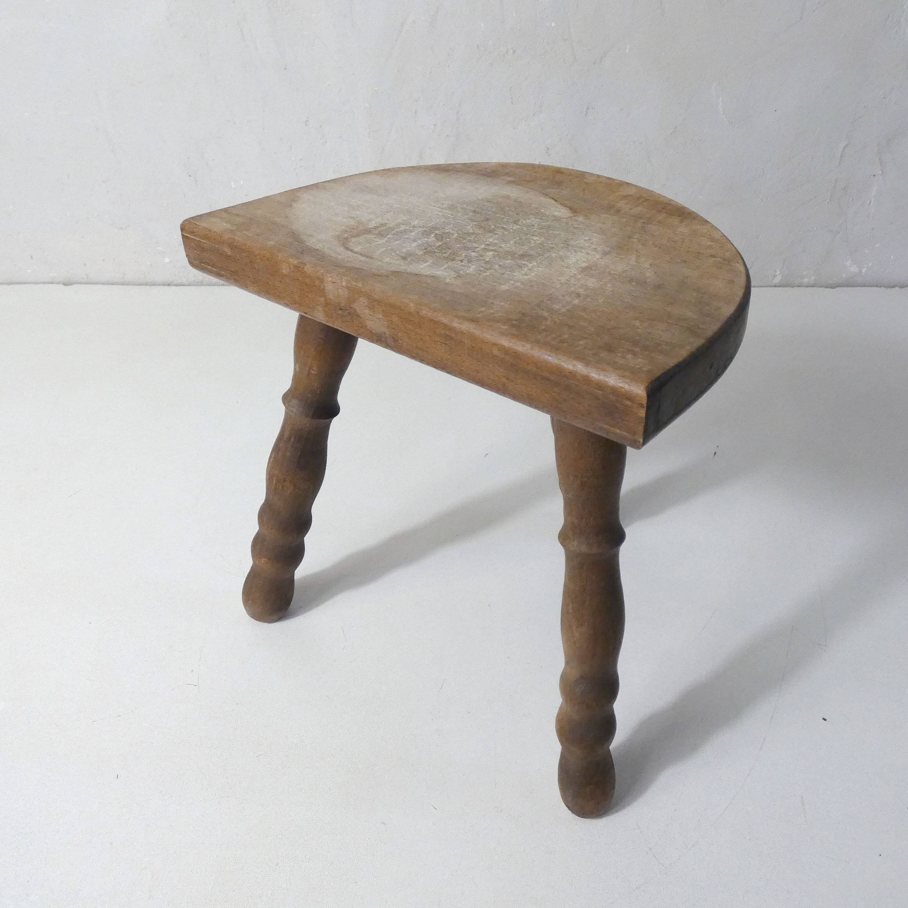 Old milking bench tripod stool in solid wood