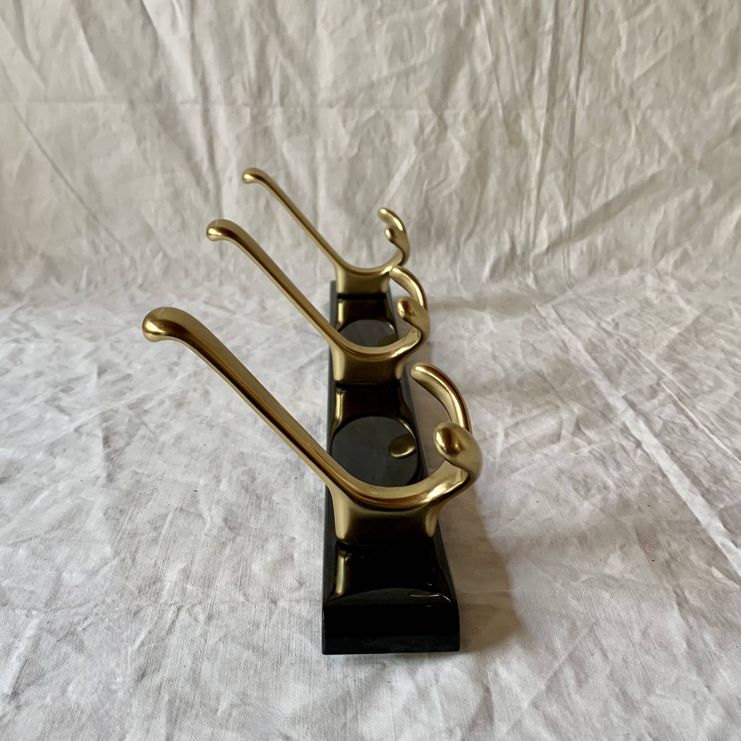Vintage coat rack in lacquered metal with three golden aluminum hooks