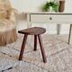 Old wooden tripod wooden farm stool made of wood