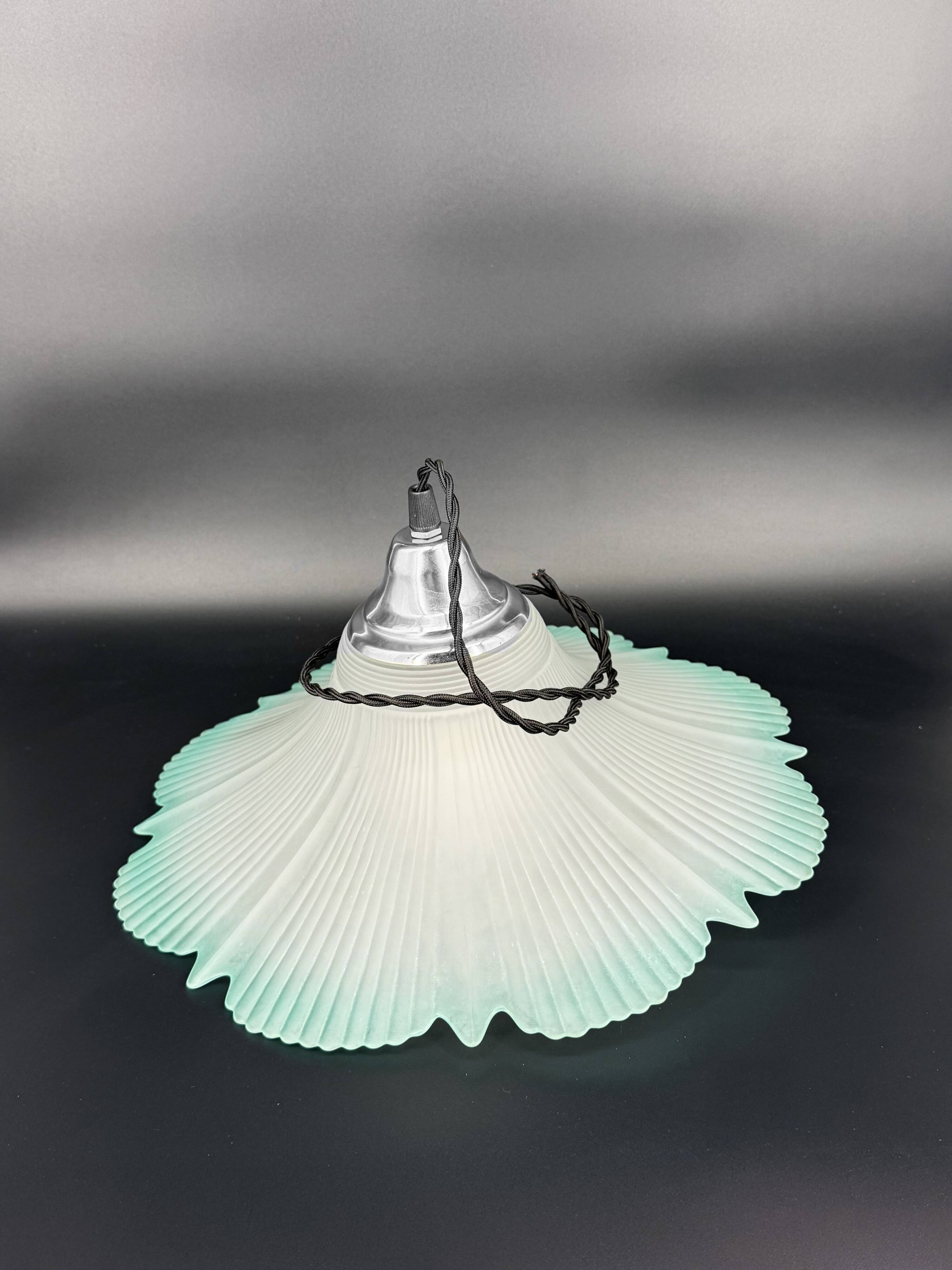 Frosted glass flower pendant with a water green edge.