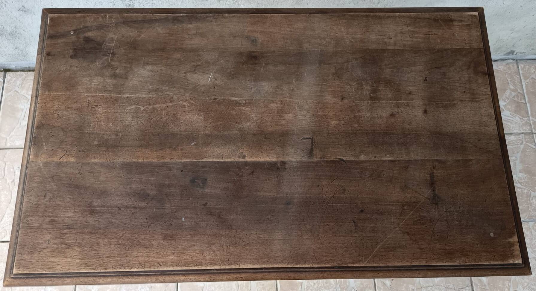 Wrought iron table with a walnut top.