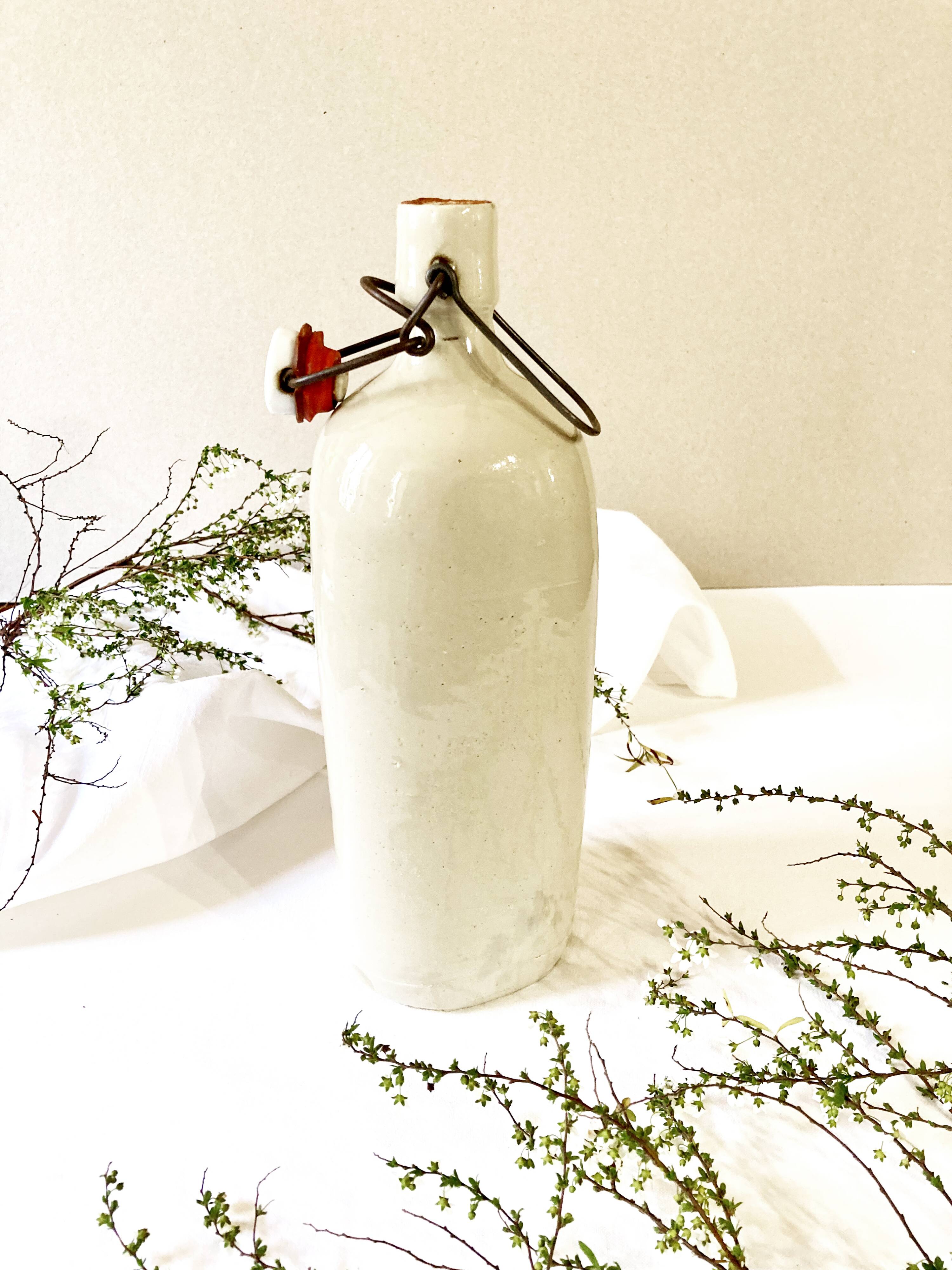 Old light gray enamelled stoneware hot water bottle