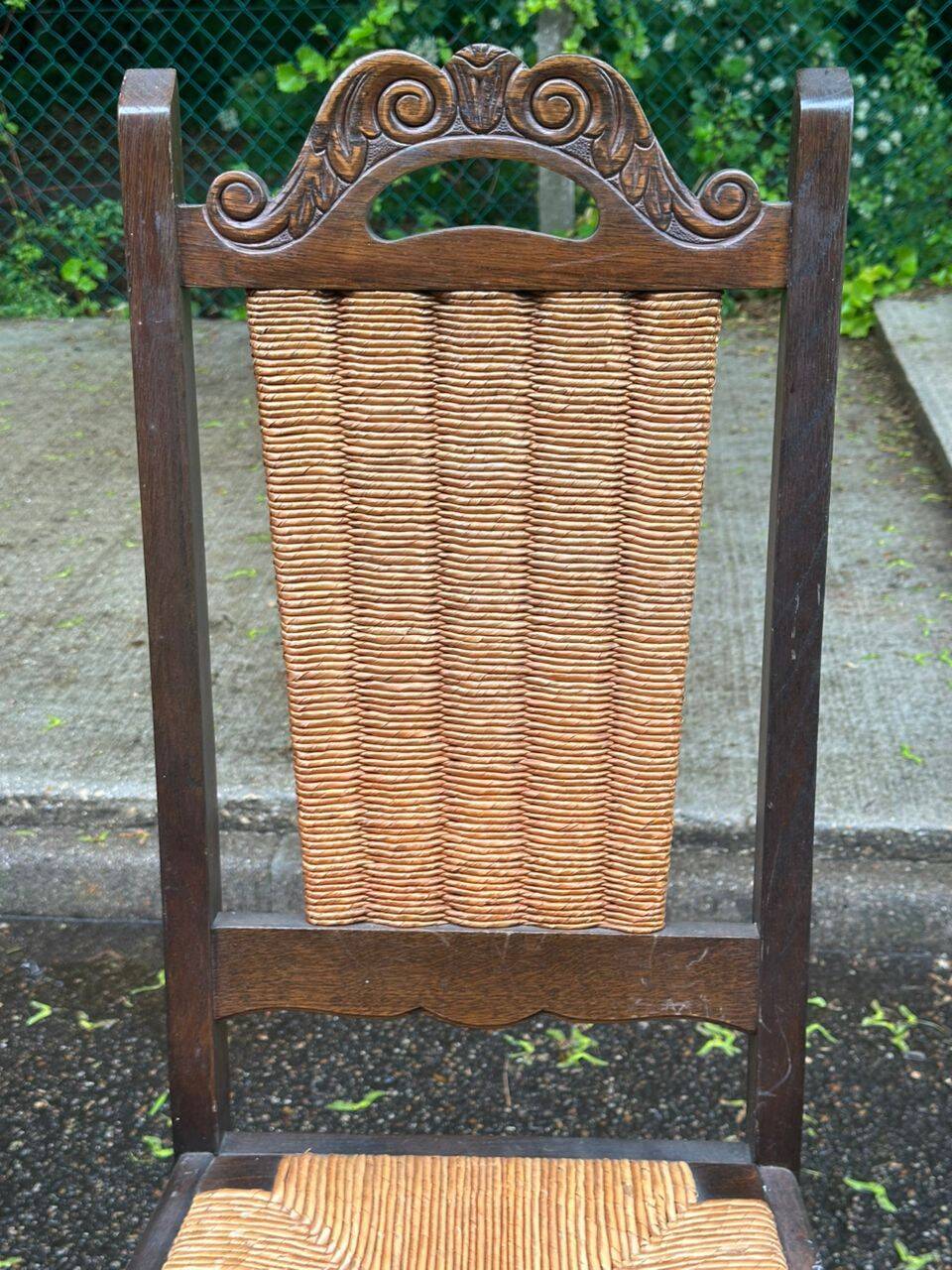 4 Basque solid wood dining chairs with carved straw seats.