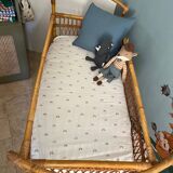 Vintage rattan baby bed with wheels