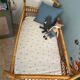 Vintage rattan baby bed with wheels