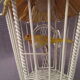 Vintage suspension cage has metal birds and raffia