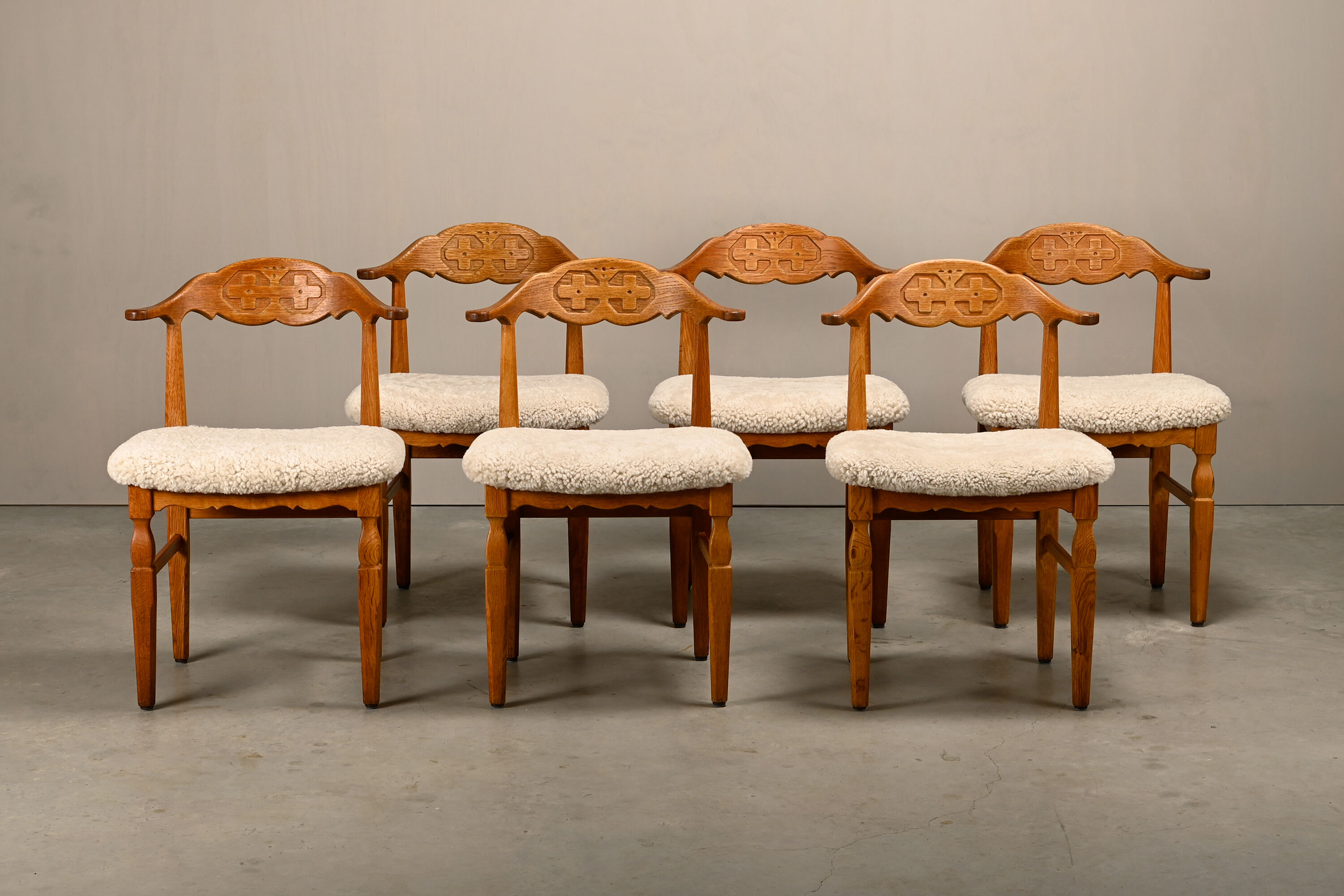 Henning Kjærnulf brutalist dining chairs set in Oak and Sheepskin, Denmark