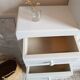 Old white asymmetrical chest of drawers