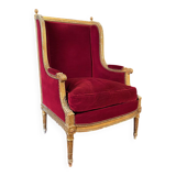 Golden wooden bergère in Louis XVI style upholstered in Bordeaux velvet.