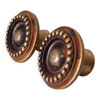 Pair of antique furniture knobs in gilded brass.