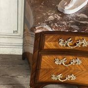 Louis XV style commode in rosewood and palisander veneer, gilt bronze mounts, and Rance marble top.