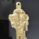 Vintage brass coat hook with marine creature motif and medallion.