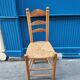 Neo-rustic chair in wood and wicker in the brutalist style by Charles Dudyoyut.