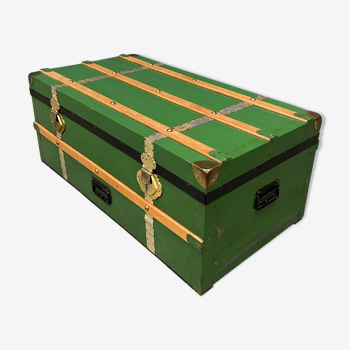 Green metal trunk with wooden sleds