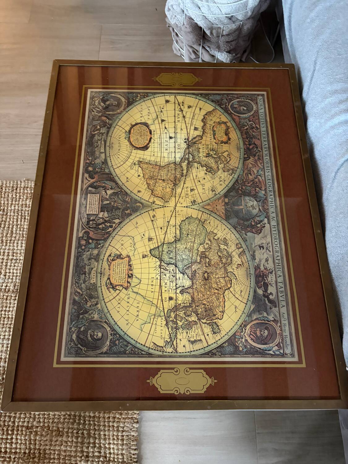 Wood and brass coffee table with a world map under glass.