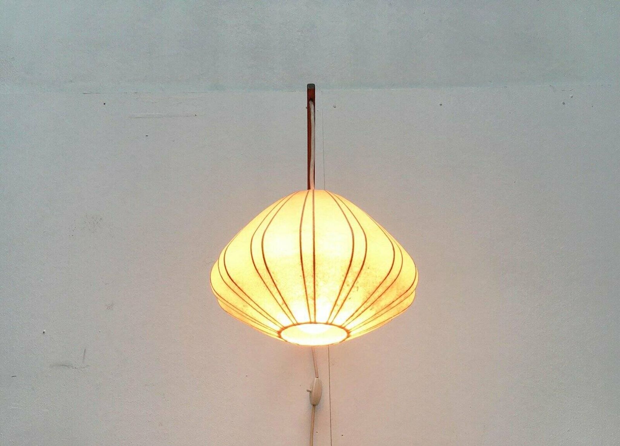 Mid-century pivoting wall lamp with a swing arm, Cocoon, made of teak wood, 1960s.