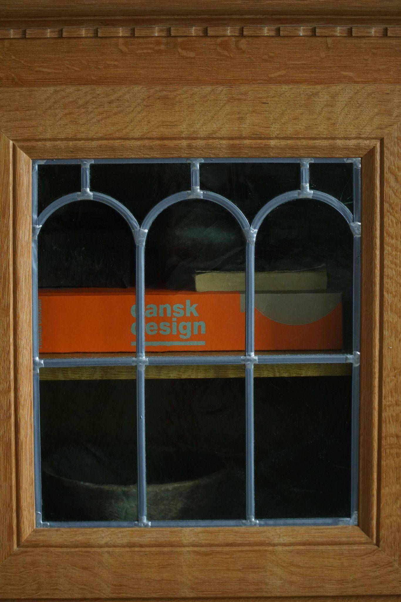 20th-century solid oak display cabinet with a glass front, by a Danish cabinetmaker.