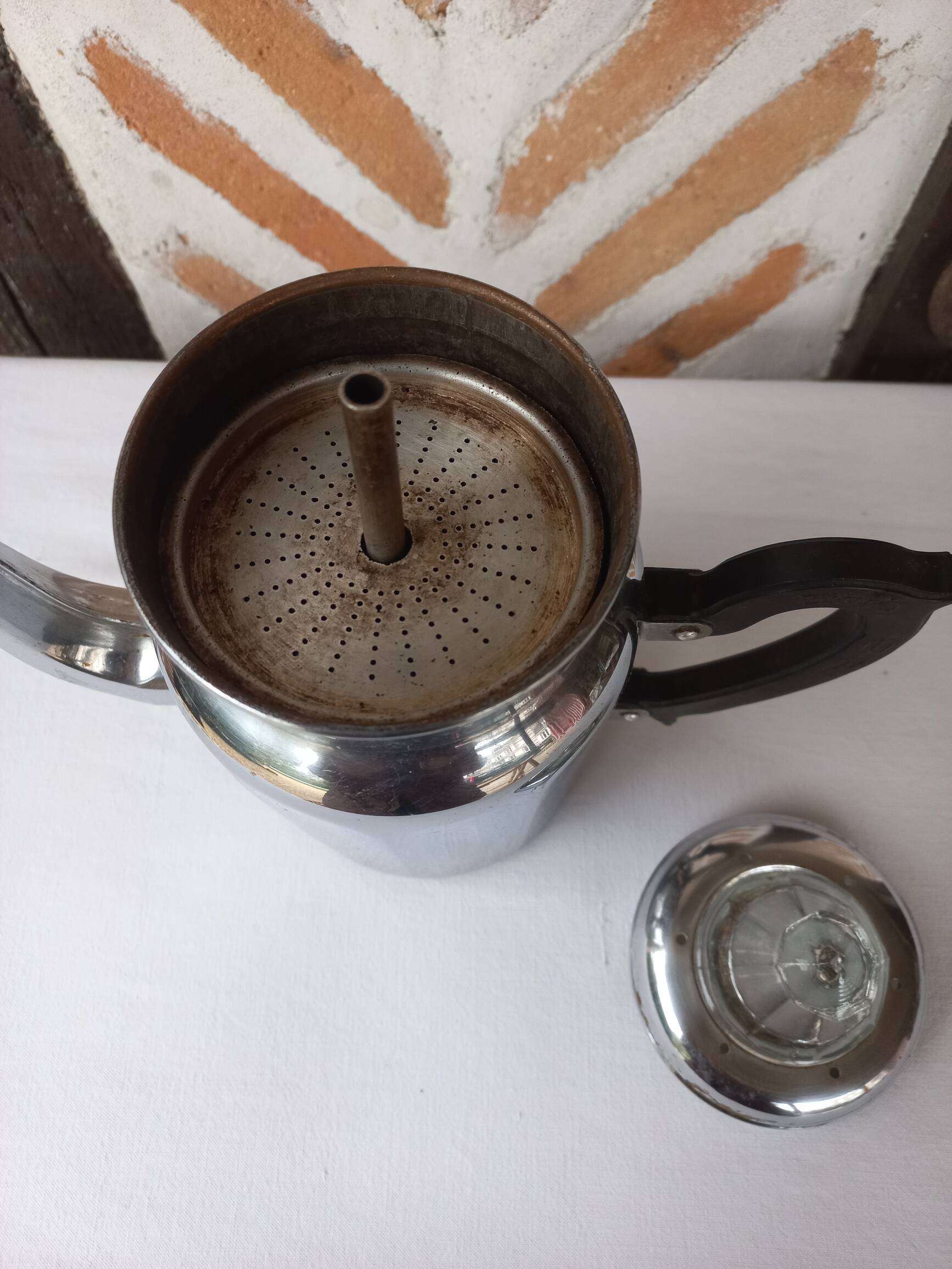 Silver metal coffee maker with glass cap