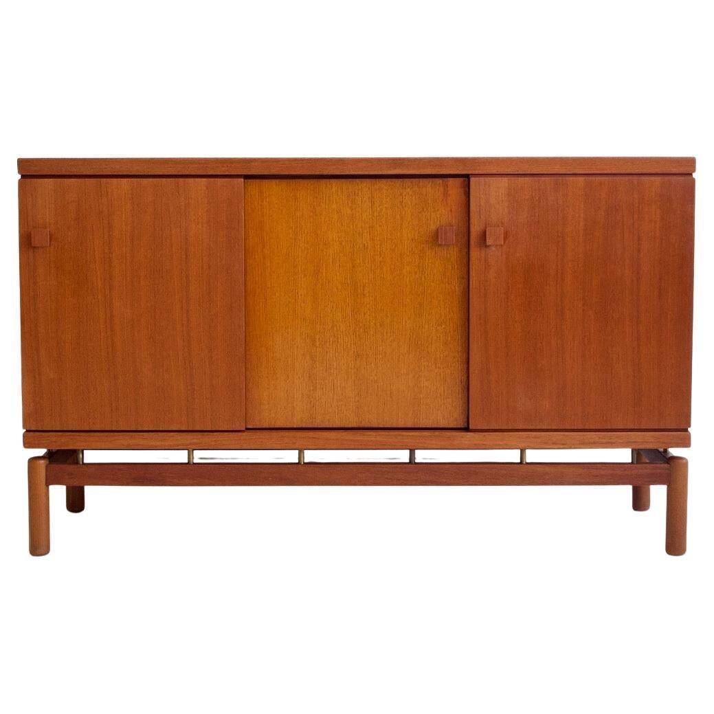 Modern mid-century teak sideboard with brass details.