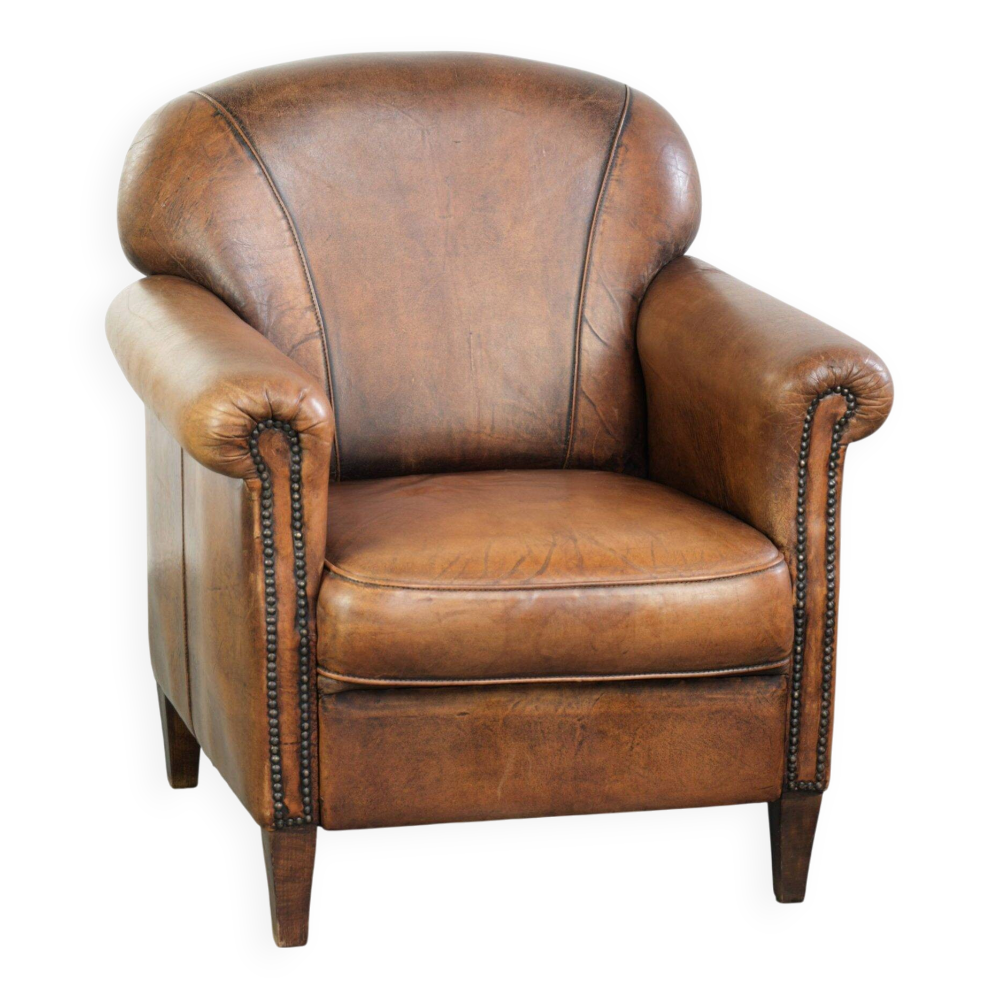 Comfortable characterful sheepskin armchair finished with decorative nails