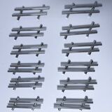Twelve 70s design metal knife holders