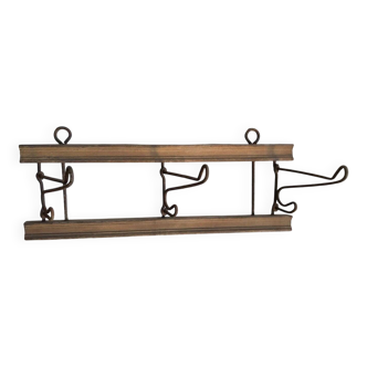 Antique wall coat rack in brown wood and iron, circa 1900, with folding hooks.