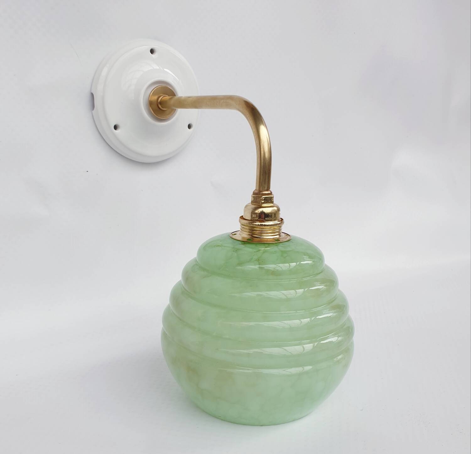 Brass collar and speckled glass wall lamp