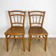 Pair of curved wood bistro chairs and studded and perforated seat
