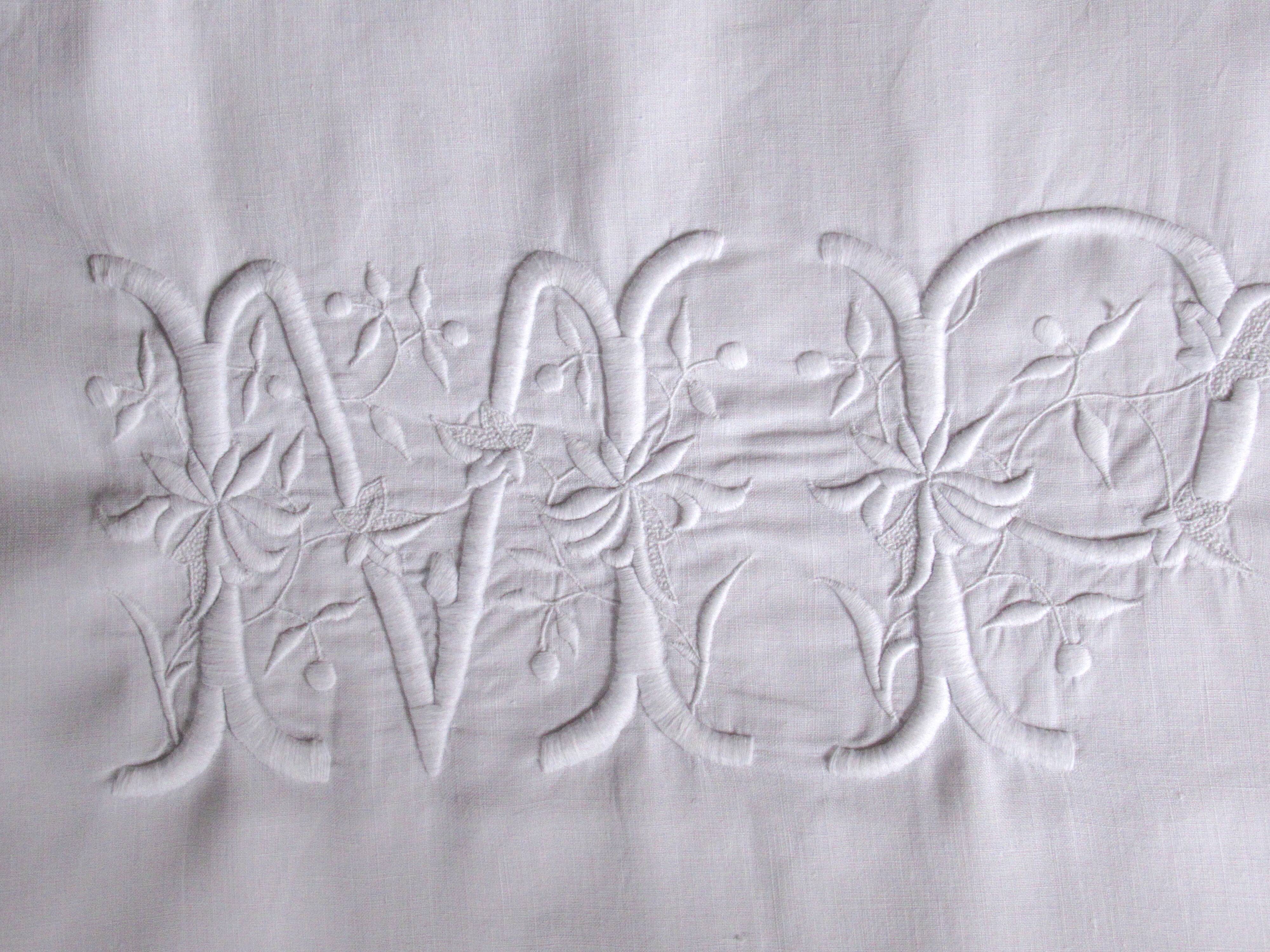 old pillowcase embroidered with fine flowers, marked MP, 19th