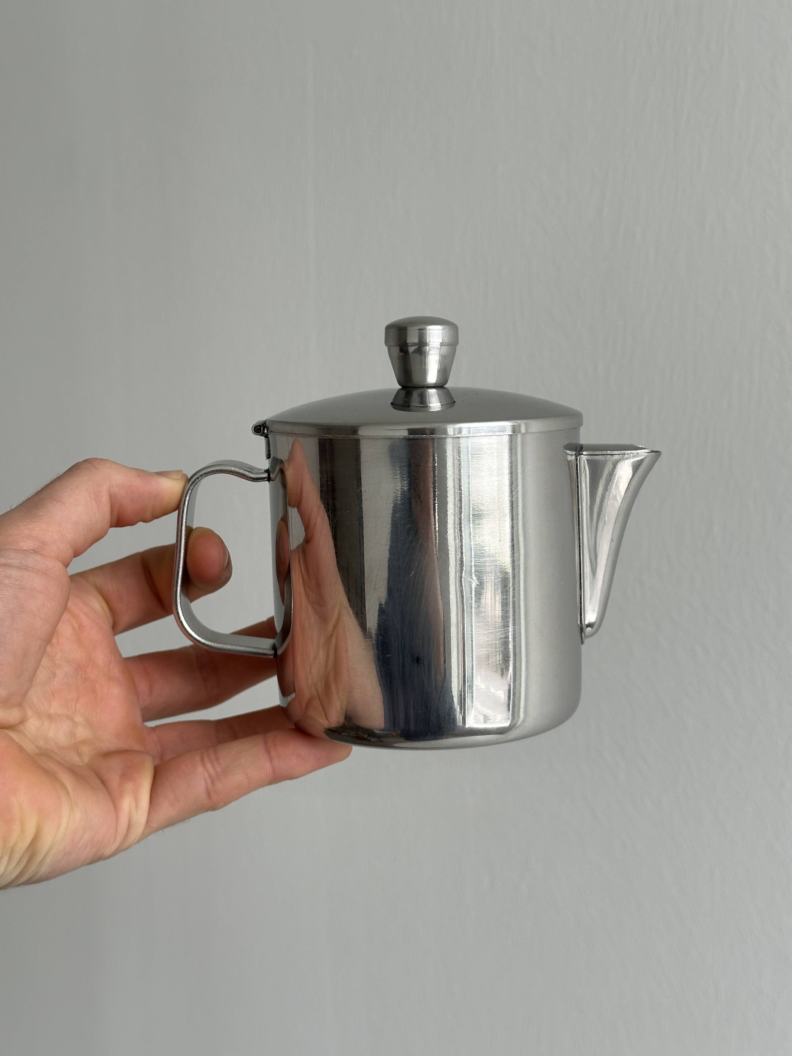 Small shiny stainless steel teapot