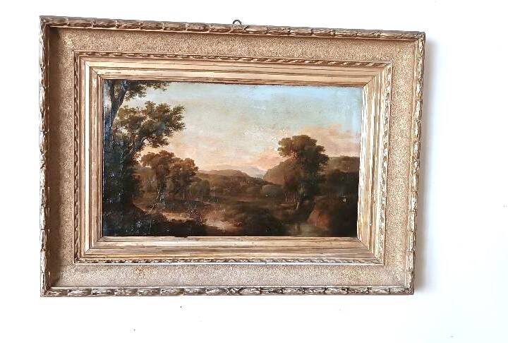 Antique painting on canvas depicting a bucolic landscape