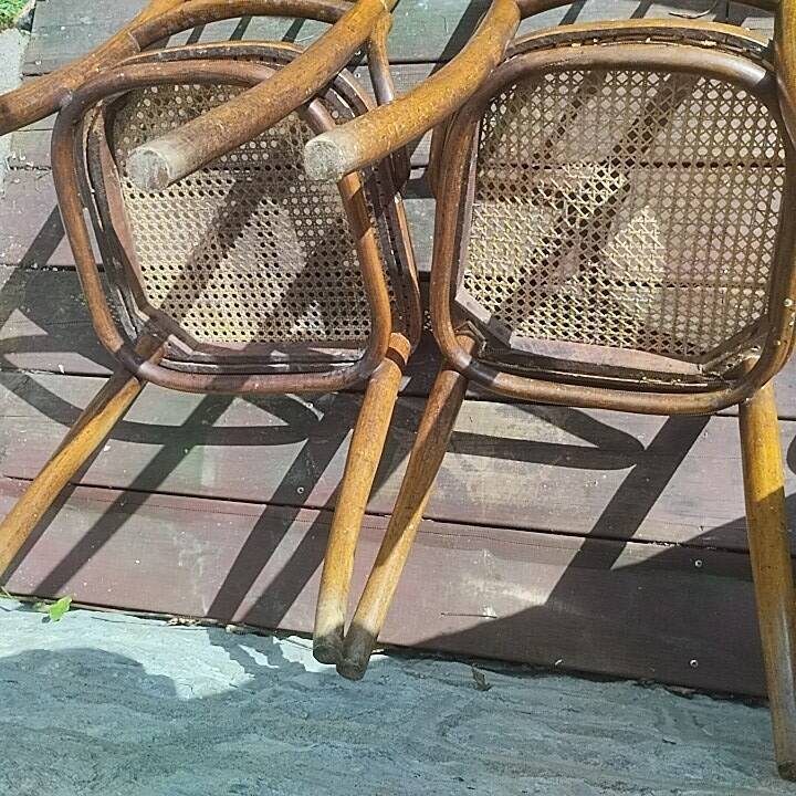 Set of 2 antique bistro chairs. Curved and turned wood.